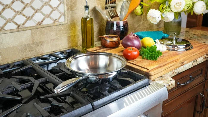 Angled view of 1.5 Quart Sauté with Cover showing stainless interior and long ergonomic handle on gas stove
