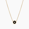 A gold-plated necklace with a black enamel and cubic zirconia disc charm on a cable chain.