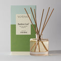 The Votivo Bamboo Leaf Reed Diffuser features fiber reeds in a glass bottle, presented with its green and blue box showing the scent name and 4 fl oz (120 ml) size.