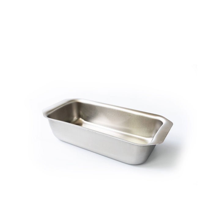 Angled view of stainless steel loaf pan with tab handles showcasing generous size and smooth interior on white background