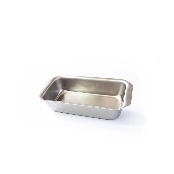 Angled view of factory‑second stainless steel loaf pan showing tab handles and roomy interior on white background