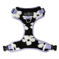 Lucy & Co. Far Out fleece no-pull dog harness in a black and white cow print with lavender trim and metal hardware.