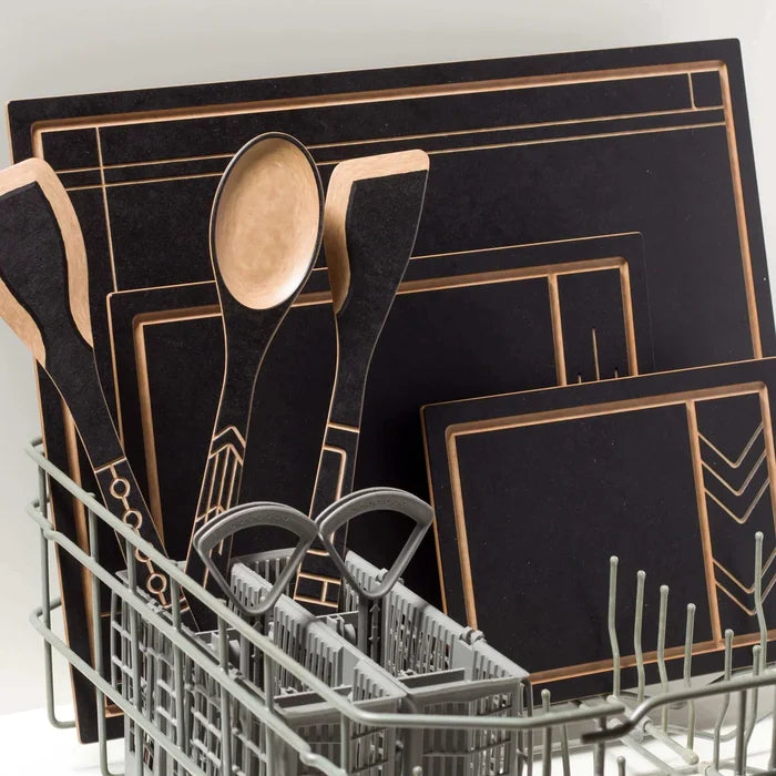 Angled view of Frank Lloyd Wright Paddle with black face, natural wood edge and geometric lines in a dishwasher utensil rack