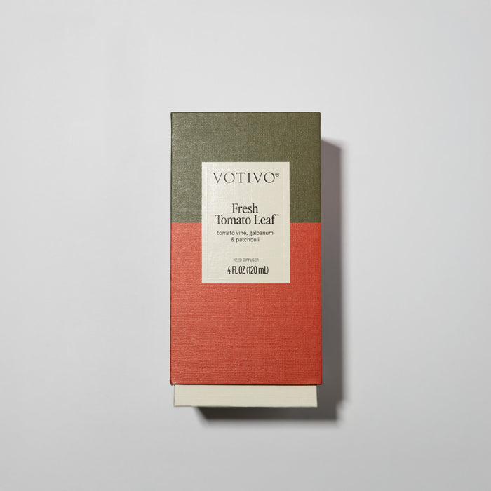 Votivo Fresh Tomato Leaf Reed Diffuser comes in a rectangular box with a green and red color-block design. The label highlights notes of tomato vine, galbanum, and patchouli, 4 fl oz (120 ml), and includes premium fiber reeds.