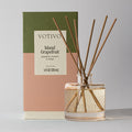 The Votivo Island Grapefruit Reed Diffuser delivers a citrus scent with grapefruit, rhubarb, and mango notes. It comes in a clear glass bottle with wooden reeds and a color-blocked green, pink, and beige box.