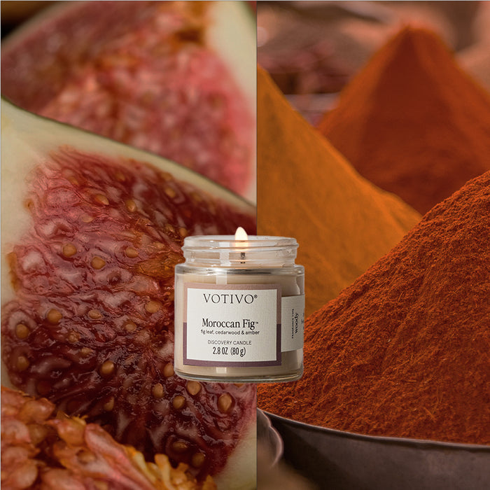 The Votivo Moroccan Fig Discovery Candle sits atop a backdrop of fresh figs and vivid spices, crafted with a premium soy blend to create an exotic, inviting ambiance.