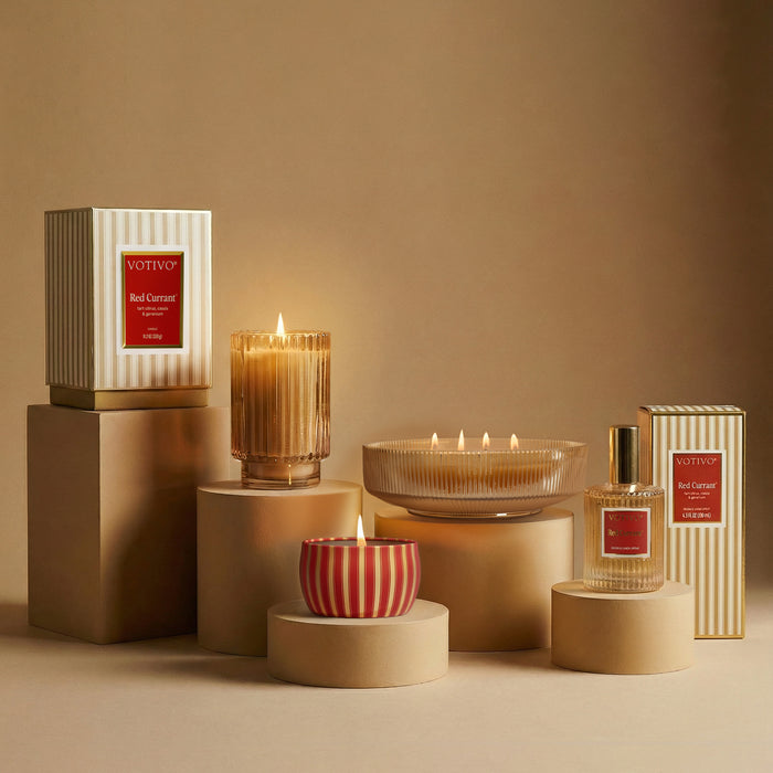 The Red Currant Holiday Collection styled with round risers against a tan background