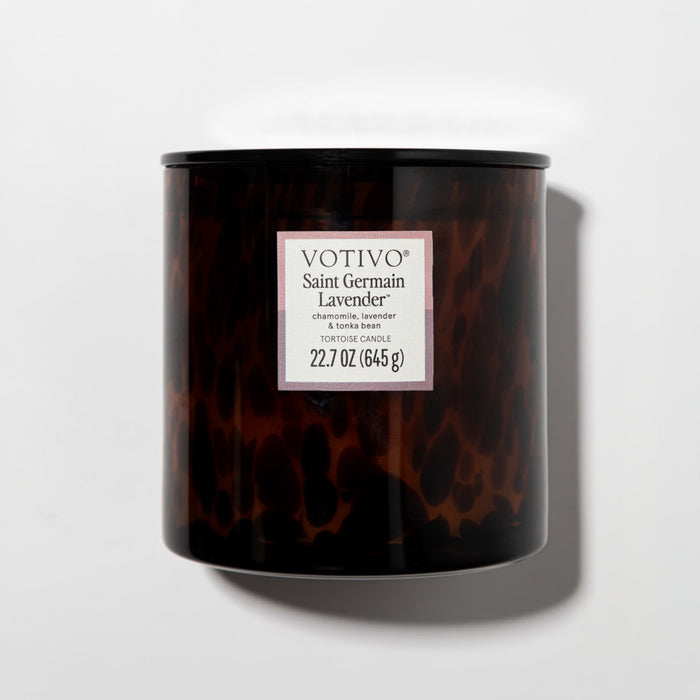 The Votivo Saint Germain Lavender Tortoise Candle, 22.7 oz soy blend, features chamomile and lavender notes in a brown tortoiseshell glass, shown against a white background.