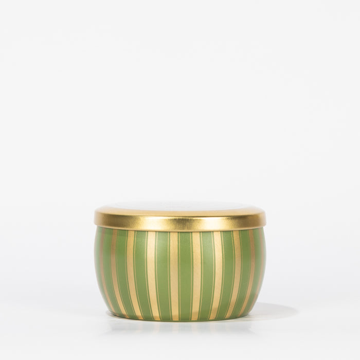 The Votivo Sequoia Fir Holiday Tin Candle features vertical gold and green stripes with a gold lid, capturing the essence of Sequoia Fir against a plain white background.
