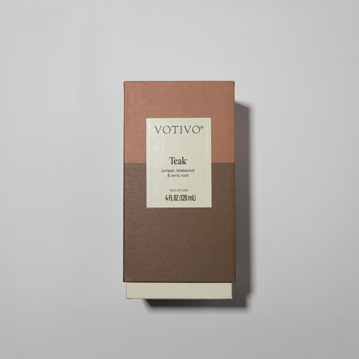 A rectangular Votivo Teak Reed Diffuser box sits on a light gray background. The brown and beige packaging features woody notes of juniper, teakwood, and iris root, with 4 fl oz (120 ml) shown on the front.