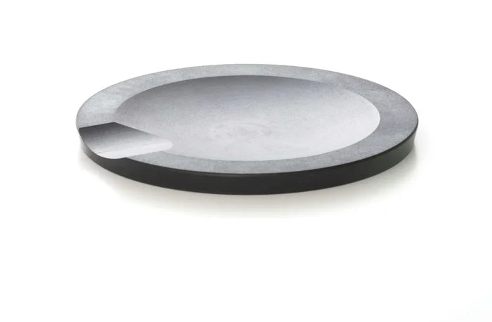 Three-quarter top view of Slate Round tool rest showing shallow recessed center and small pour notch on white background