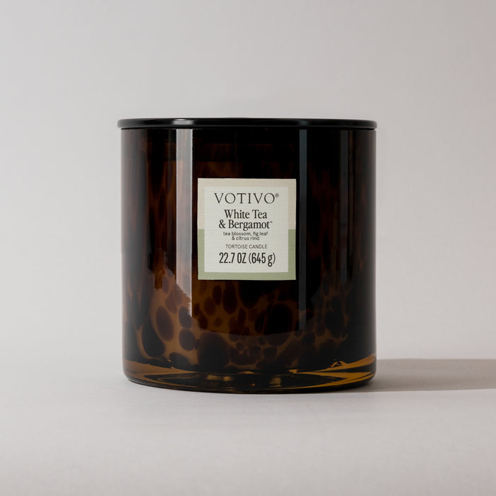 A Votivo White Tea & Bergamot Tortoise Candle, 22.7 oz (645g), made with a soy blend and housed in a brown mottled glass jar, is shown against a plain light background.